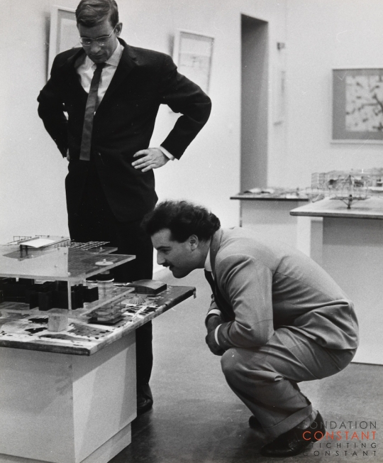 Constant-Schulze Fielitz, German architect, and Swiss painter André Thomkins in front of model Red Sector, 1961 Constant Nieuwenhuys-Schulze Fielitz, German architect, and Swiss painter André Thomkins in front of model Red Sector, 1961